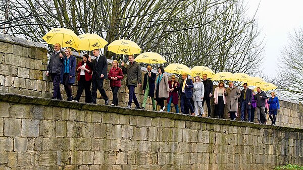 Liberal Democrat Leader walks along the York walls with MPs and candidates