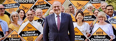 Ed Davey with a crowd holding Lib Dem signs