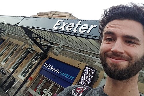 Will Aczel in front of Exeter St David's train station
