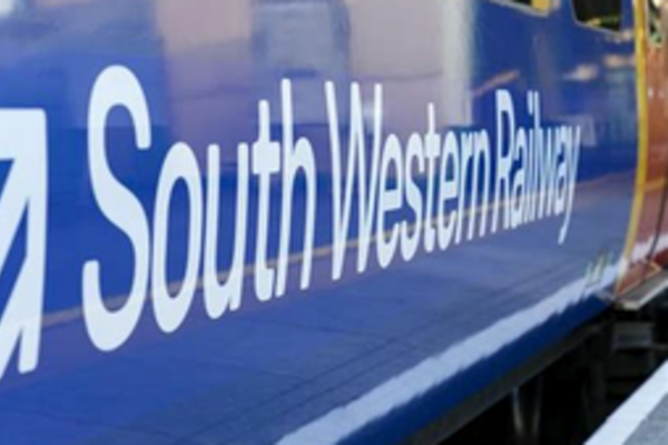 The side of a South Western Railway train showing their name and logo.