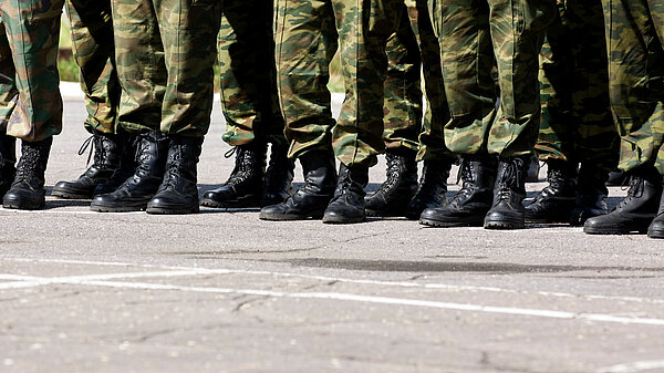 Soldiers' boots lined up on tarmac