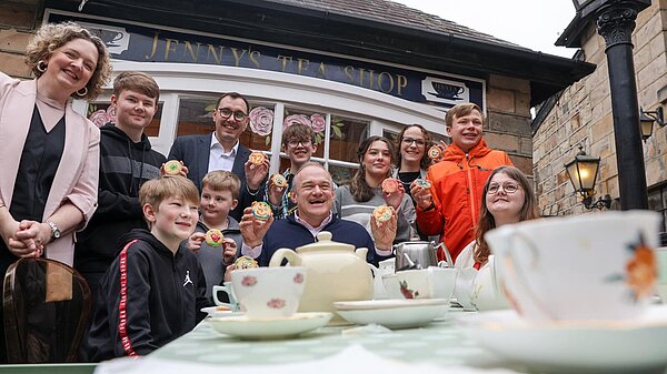 Ed Davey at a tea shop with a group of young carers