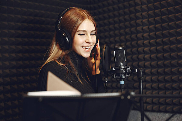 Recording studio A woman and a microphone in a recording studio