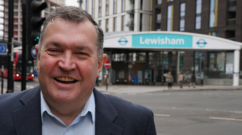 Chris Maines standing in front of Lewisham DLR station