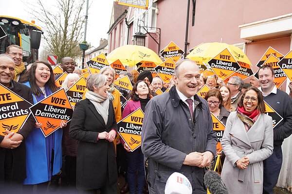 Ed Davey in front of crowd with Lib Dem diamond signs