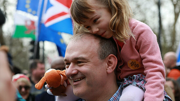 Ed Davey with a child on his shoulders
