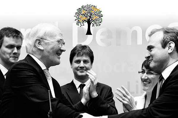 Black and white photo of Liberal Democrats, including Menzies Campbell, Nick Clegg and Ed Davey, and the Legacy Society logo