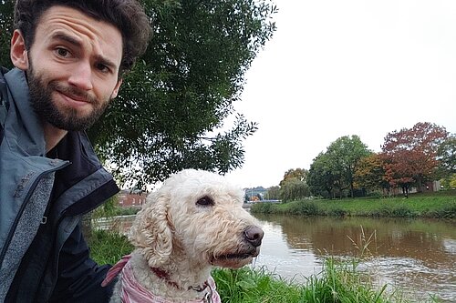 Will Aczel with dog Ayla by the River Exe, near Exeter Quay 