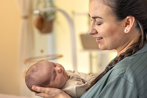 A mother holds their baby