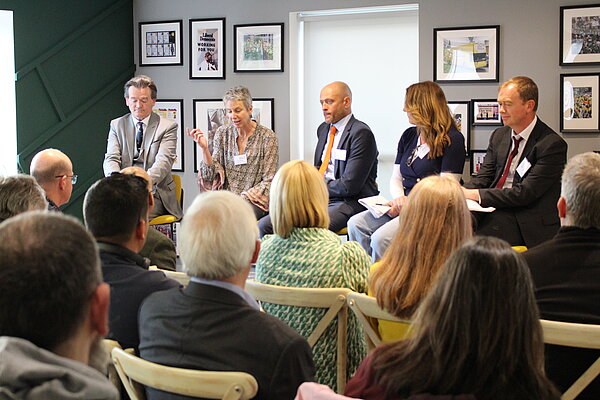 A panel of five people, including Fergal Sharkey and Tim Farron MP, speak to a seated audience at Lib Dem HQ.