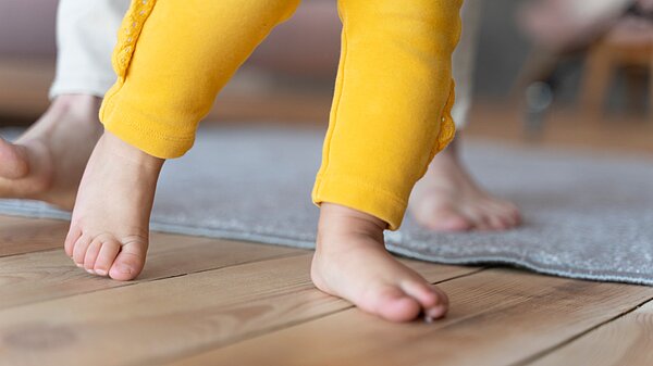 Toddler taking early steps