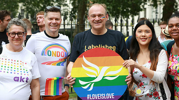 Ed Davey with fellow Liberal Democrats at pride holding a Lib Dem pride poster