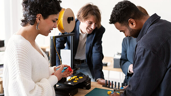 Four people in a practical training setting, solving a problem
