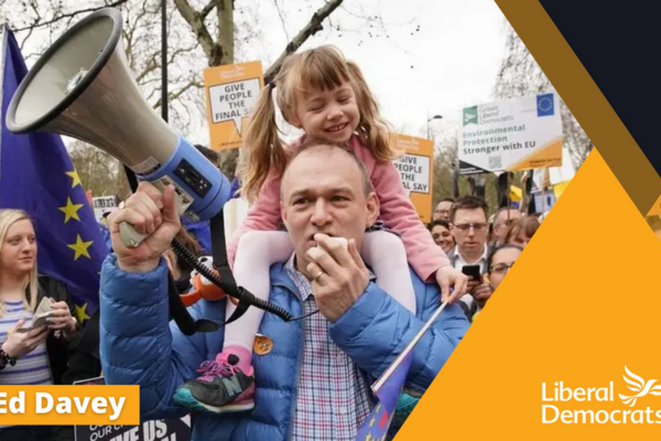 Ed Davey in front of a crowd on a Lib Dem membership card