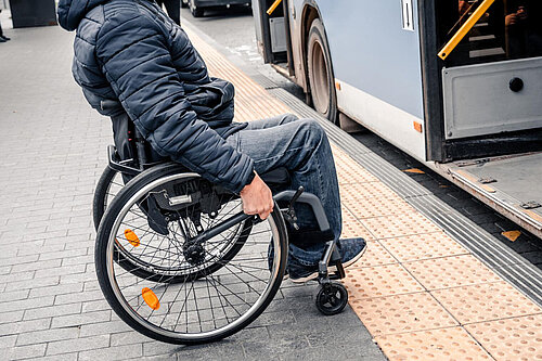Wheelchair A wheelchair user approaches a bus door