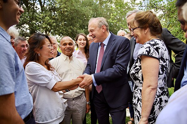 Ed Davey handshake Ed Davey shakes hands with a woman