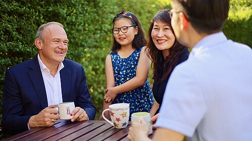 Ed Davey listens to a family
