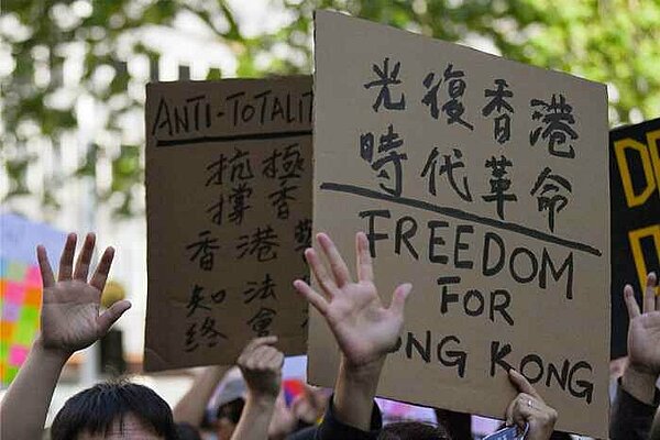 A person holding a sign with the message "Freedom for Hong Kong"