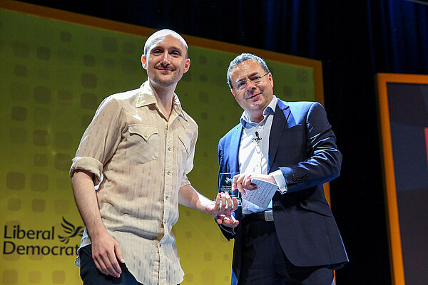 Fred Fisher receives an award from Party President Mark Pack on behalf of Simon Mackenzie