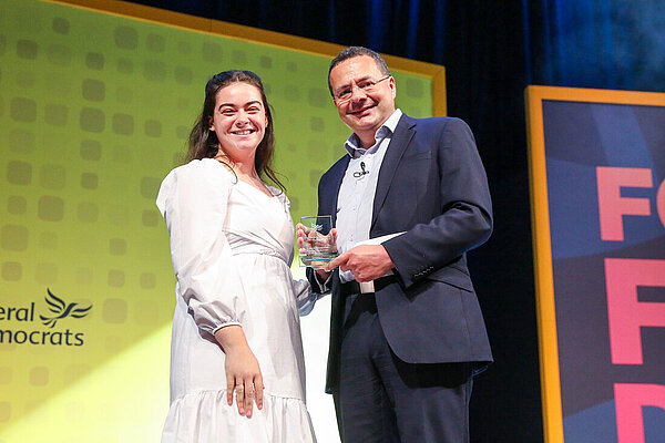 Rebecca Turner and Liverpool Lib Dems receives an award from Party President Mark Pack