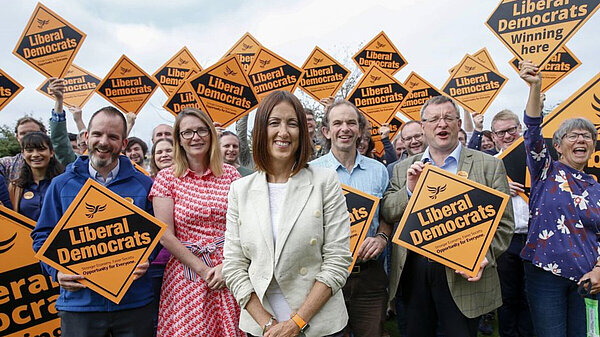 Jane Dodds with a group of Welsh Liberal Democrats holding posters