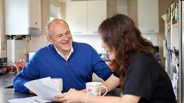 Ed Davey speaking with a constituent about her bills